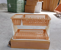 Modern black dish rack with various kitchen utensils draining into a tray.