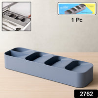 A plastic cutlery tray neatly filled with spoons, forks, and knives in a kitchen drawer.