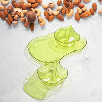 Side view of the versatile apple-shaped serving set for pickles and dips.
