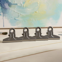 Reusable metal binder clips holding bills and notes securely