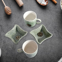 A person enjoying chai and snacks with the versatile ceramic tea and coffee cup set.