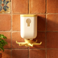Rotating sticky wall hook attached to a glass surface