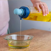Versatile oil dispenser bottle used for cooking, baking, and dressing salads with precision.