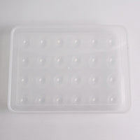 Clear plastic egg container next to traditional egg carton for size comparison