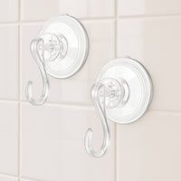 Four plastic suction cup hooks arranged for hanging items