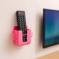 Four pieces of wall mounted remote holders in a clean, minimalist setting.