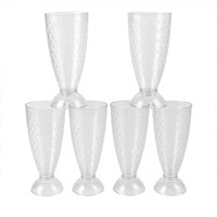 Transparent plastic milkshake glasses neatly arranged on a dining table