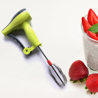 A manual hand blender being used to make a refreshing glass of lassi.