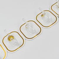 Transparent adhesive hooks installed on a white wall, blending seamlessly with home decor.