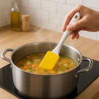 Assorted silicone spatulas and pastry brushes arranged in a modern kitchen setting.