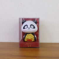 Multiple solar panda figurines in various poses, emphasizing their charm as car interior accessories.