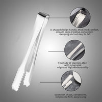 Set of two stainless steel serving tongs on a clear glass plate.