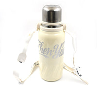 The 1200ML hot and cold water bottle being carried comfortably by its handle.