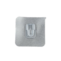 GlimmerHome transparent adhesive hook discreetly blending into a white wall.