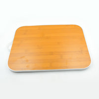 Versatile bamboo cutting board used for various kitchen tasks like slicing vegetables.