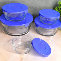Glass bowls with lids used for mixing ingredients in a modern kitchen setting.