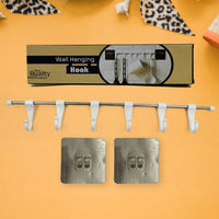 The utensil hanger rail mounted on a kitchen wall, neatly holding various kitchen ladles and tools.