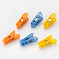Durable non-slip plastic clips for laundry drying in bright colours.