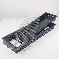 The compact charcoal cooker positioned on a picnic table, ready for grilling.