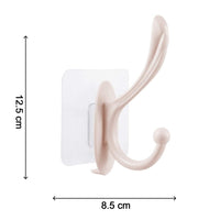 A heavy-duty self adhesive wall hook holding various items like keys and a small bag.