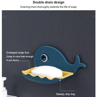 Fish shape soap dish holding a bar of soap, illustrating its perfect fit and wall adhesion.
