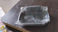 Compact soap dish holder neatly mounted in a shower area, saving space.