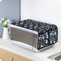 Folded cotton linen microwave cover displayed neatly on a kitchen counter.
