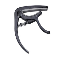 Wagtail guitar capo securely clamped on an acoustic guitar neck.