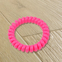 Assorted colors of durable telephone wire hair ties.