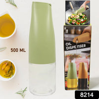 Close-up of the non-drip spout of the 500ml oil dispenser during pouring.