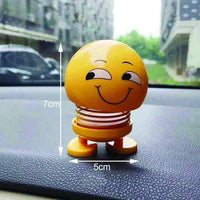 Angled view of an emoticon spring figure with a cheerful smiling face on a white background.