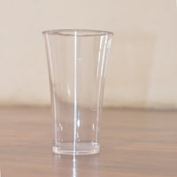 Stack of transparent plastic water glasses for compact storage.