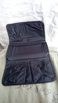Lifestyle shot of the sofa armrest organizer keeping a living room tidy.