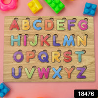 Toddler hands engaging with the vibrant wooden ABC and shape learning puzzle.