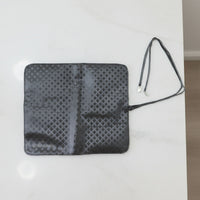 Inside view of foldable makeup brush organizer pouch displaying multiple slots