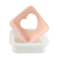 Close-up of heart bread mold design on sandwich cutter