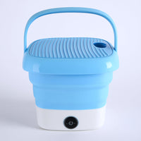 Mini folding washer on a clean background, highlighting its compact size for travel.