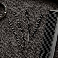 Detailed close-up of black bobby pin with smooth tips
