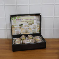 Tea cup and saucer set featuring classic floral design with gold accents
